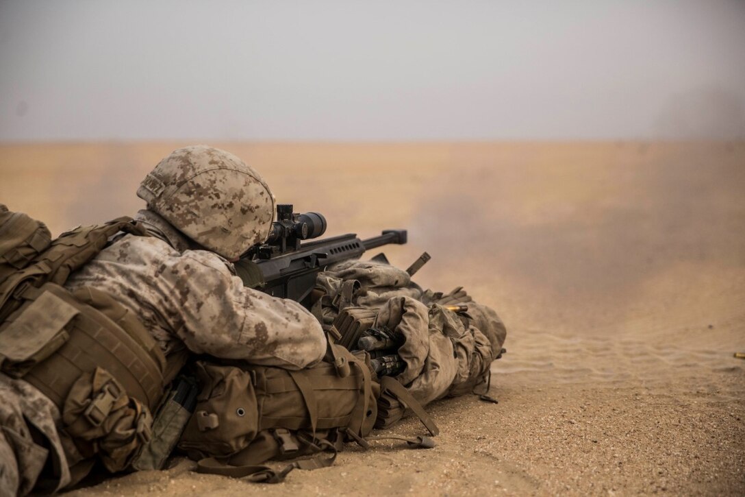 KUWAIT (Aug. 31, 2015) U.S. Marine Cpl. Erik Troutz fires a special application scoped rifle at a target during a sniper shoot. Troutz is a scout sniper with Weapons Company, Battalion Landing Team, 3rd Battalion, 1st Marine Regiment, 15th Marine Expeditionary Unit. During the training, Marines engaged targets at unknown distances ranging from 300 to more than 1,000 yards. Elements of the 15th MEU are ashore in Kuwait for sustainment training to maintain and enhance the skills they developed during their pre-deployment training period. The 15th MEU is embarked aboard the Essex Amphibious Ready Group and deployed to maintain regional security in the U.S. 5th Fleet area of operations. (U.S. Marine Corps photo by Sgt. Emmanuel Ramos/Released)