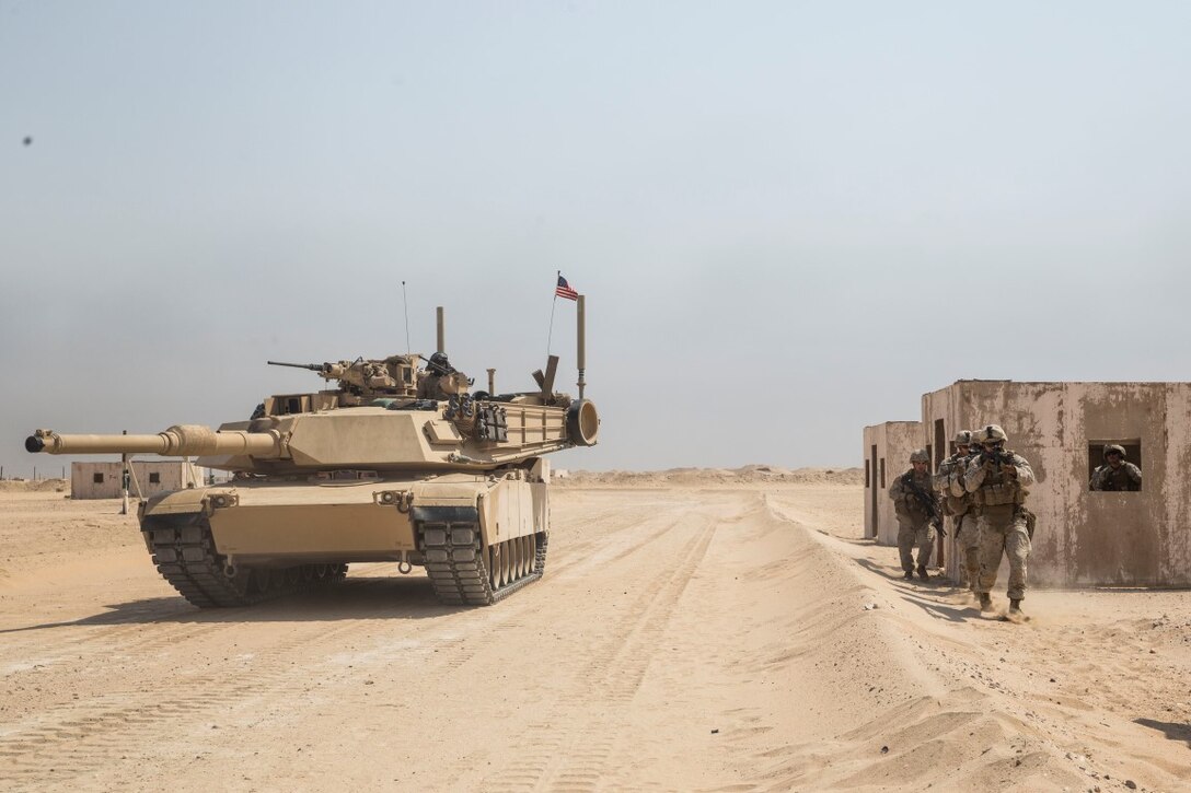 KUWAIT (Aug. 28, 2015) U.S. Marines with Kilo Company, Battalion Landing Team 3rd Battalion, 1st Marine Regiment, 15th Marine Expeditionary Unit, rehearse urban patrolling techniques as an M1A1 Abrams tank provides security during military operations in urban terrain training. During the training Marines rehearsed patrolling through urban areas and immediate action drills. Elements of the 15th MEU are ashore in Kuwait for sustainment training to maintain and enhance the skills they developed during their pre-deployment training period.  The 15th MEU is embarked aboard the Essex Amphibious Ready Group and deployed to maintain regional security in the U.S. 5th Fleet area of operations. (U.S. Marine Corps photo by Sgt. Emmanuel Ramos/Released)