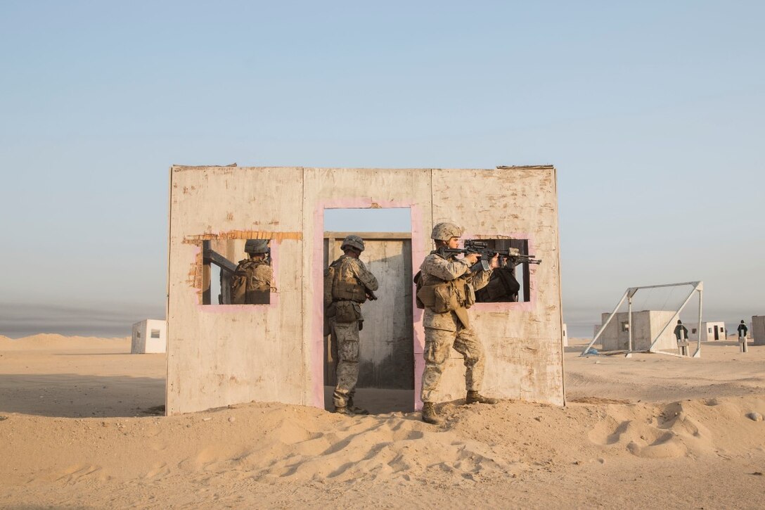 KUWAIT (Aug. 28, 2015) U.S. Marines with Kilo Company, Battalion Landing Team 3rd Battalion, 1st Marine Regiment, 15th Marine Expeditionary Unit, clear a room of threats during military operations in urban terrain training. During the training Marines rehearsed patrolling through urban areas and immediate action drills. Elements of the 15th MEU are ashore in Kuwait for sustainment training to maintain and enhance the skills they developed during their pre-deployment training period.  The 15th MEU is embarked aboard the Essex Amphibious Ready Group and deployed to maintain regional security in the U.S. 5th Fleet area of operations. (U.S. Marine Corps photo by Sgt. Emmanuel Ramos/Released)
