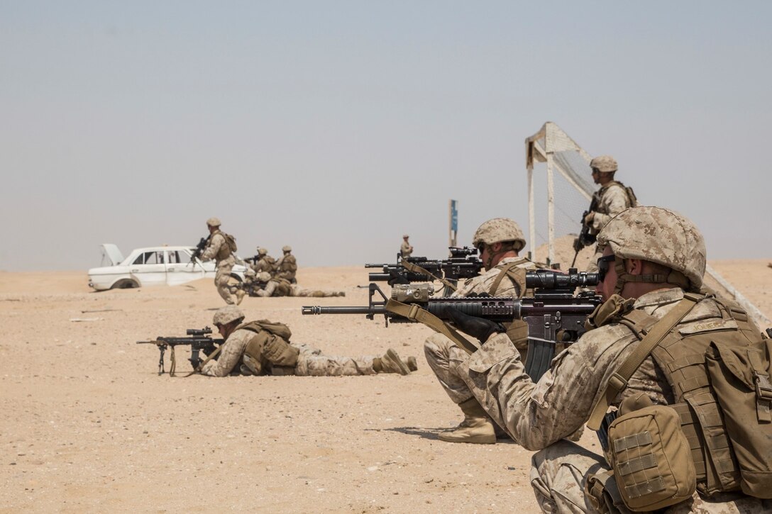 KUWAIT (Aug. 28, 2015) U.S. Marines with Kilo Company, Battalion Landing Team, 3rd Battalion, 1st Marine Regiment, 15th Marine Expeditionary Unit, clear through an urban environment. During the training, Marines learned how to incorporate an M1A1 Abrams tank in squad attacks in an urban environment. Elements of the 15th MEU are ashore in Kuwait for sustainment training to maintain and enhance the skills they developed during their pre-deployment training period.  The 15th MEU is embarked aboard the Essex Amphibious Ready Group and deployed to maintain regional security in the U.S. 5th Fleet area of operations. (U.S. Marine Corps photo by Sgt. Emmanuel Ramos/Released)