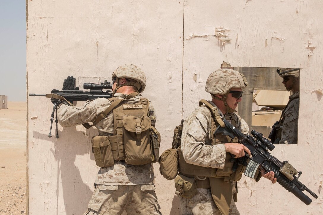 KUWAIT (Aug. 28, 2015) U.S. Marines with Kilo Company, Battalion Landing Team, 3rd Battalion, 1st Marine Regiment, 15th Marine Expeditionary Unit, clear an urban environment. During the training, Marines learned how to incorporate an M1A1 Abrams tank in squad attacks in an urban environment. Elements of the 15th MEU are ashore in Kuwait for sustainment training to maintain and enhance the skills they developed during their pre-deployment training period.  The 15th MEU is embarked aboard the Essex Amphibious Ready Group and deployed to maintain regional security in the U.S. 5th Fleet area of operations. (U.S. Marine Corps photo by Sgt. Emmanuel Ramos/Released)