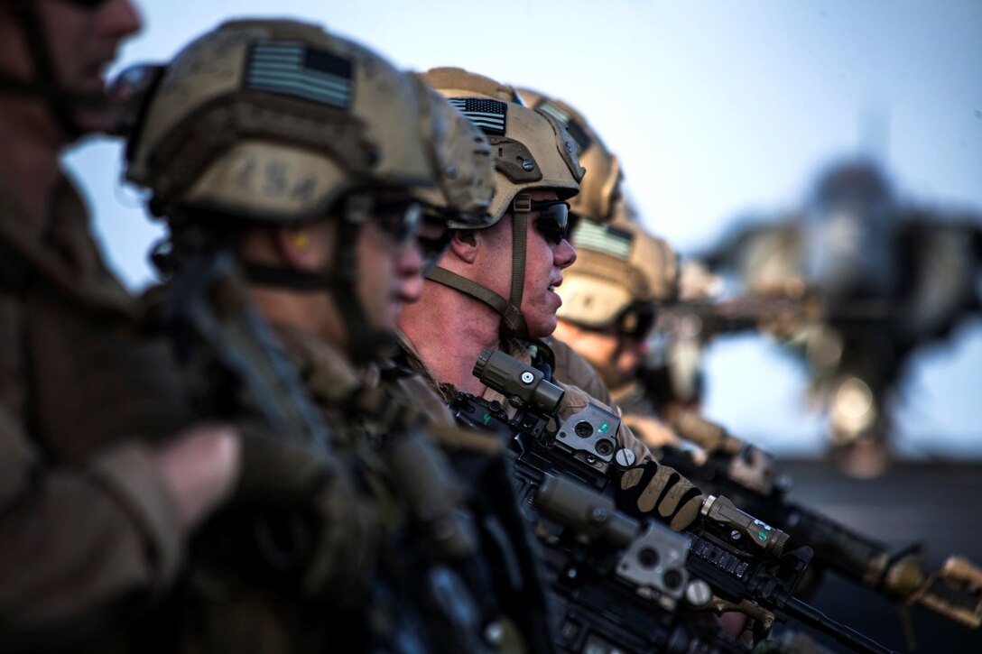 ARABIAN GULF (Sept. 21, 2015) U.S. Marines with the 15th Marine Expeditionary Unit’s Maritime Raid Force wait for the command to fire at their respective targets during a deck shoot aboard the amphibious assault ship USS Essex (LHD 2). The 15th MEU is embarked aboard the Essex Amphibious Ready Group and deployed to maintain regional security in the U.S. 5th Fleet area of operations. (U.S. Marine Corps photo by Cpl. Elize McKelvey/Released)