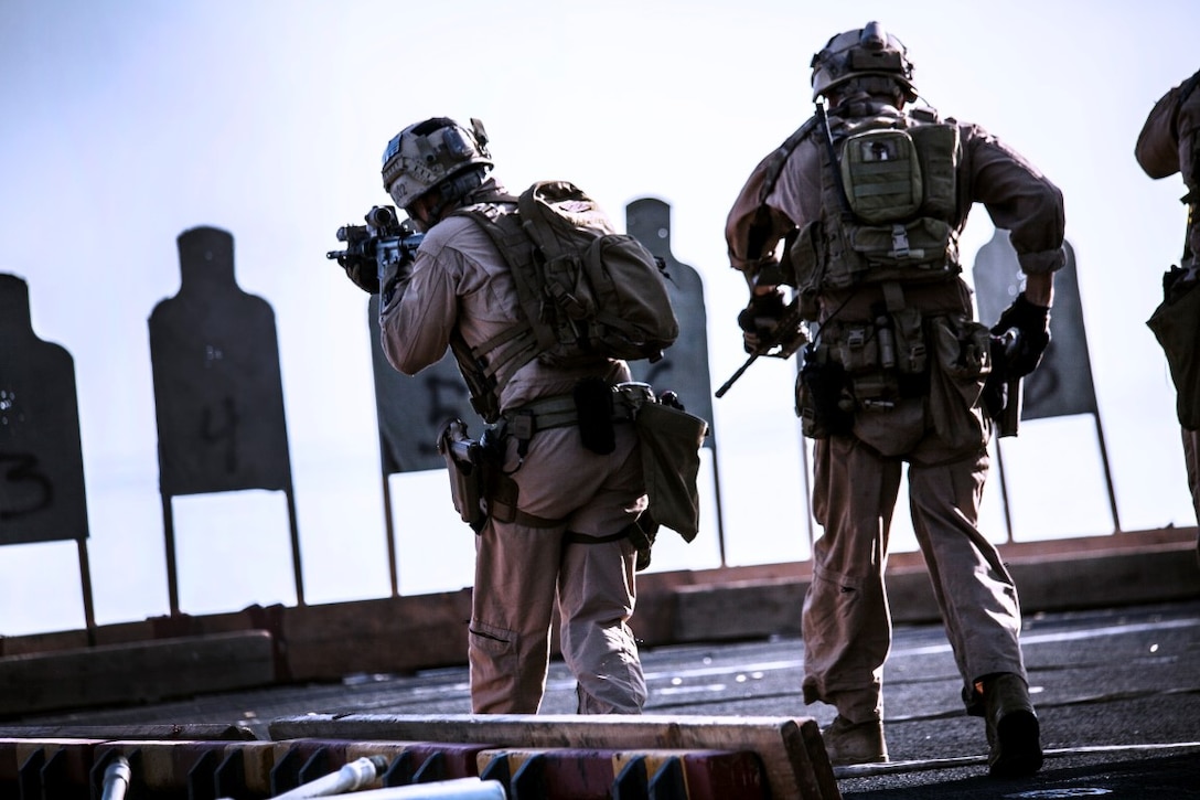 ARABIAN GULF (Sept. 21, 2015) U.S. Marines with the 15th Marine Expeditionary Unit’s Maritime Raid Force engage targets while moving forward during a deck shoot aboard the amphibious assault ship USS Essex (LHD 2). The 15th MEU is embarked aboard the Essex Amphibious Ready Group and deployed to maintain regional security in the U.S. 5th Fleet area of operations. (U.S. Marine Corps photo by Cpl. Elize McKelvey/Released)