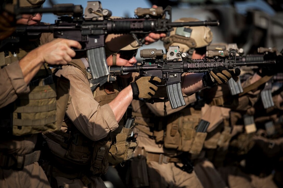 ARABIAN GULF (Sept. 21, 2015) U.S. Marines with the 15th Marine Expeditionary Unit’s Maritime Raid Force engage targets while moving forward during a deck shoot aboard the amphibious assault ship USS Essex (LHD 2). The 15th MEU is embarked aboard the Essex Amphibious Ready Group and deployed to maintain regional security in the U.S. 5th Fleet area of operations. (U.S. Marine Corps photo by Cpl. Elize McKelvey/Released)
