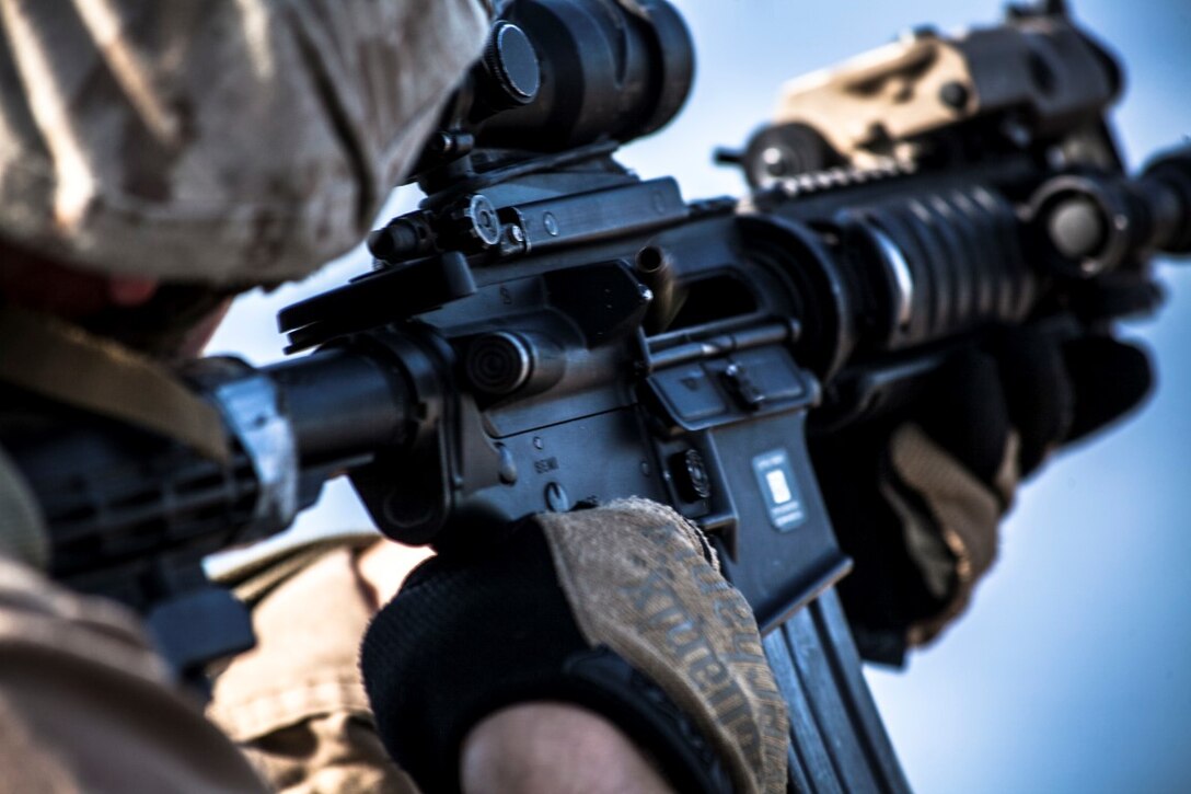 ARABIAN GULF (Sept. 21, 2015) A U.S. Marine with the 15th Marine Expeditionary Unit’s Maritime Raid Force fires his weapons at a target during a deck shoot aboard the amphibious assault ship USS Essex (LHD 2). The 15th MEU is embarked aboard the Essex Amphibious Ready Group and deployed to maintain regional security in the U.S. 5th Fleet area of operations. (U.S. Marine Corps photo by Cpl. Elize McKelvey/Released)
