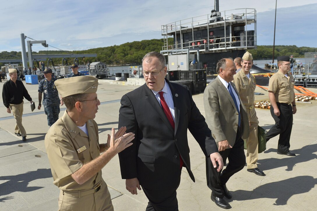 Deputy Defense Secretary Bob Work walks with Navy Vice Adm. Joseph E. Tofalo, commander of submarine forces, as he visits Groton Submarine Base in New London, Conn., Sept. 22, 2015. The USS New Hampshire sits in the background. DoD photo by Glenn Fawcett