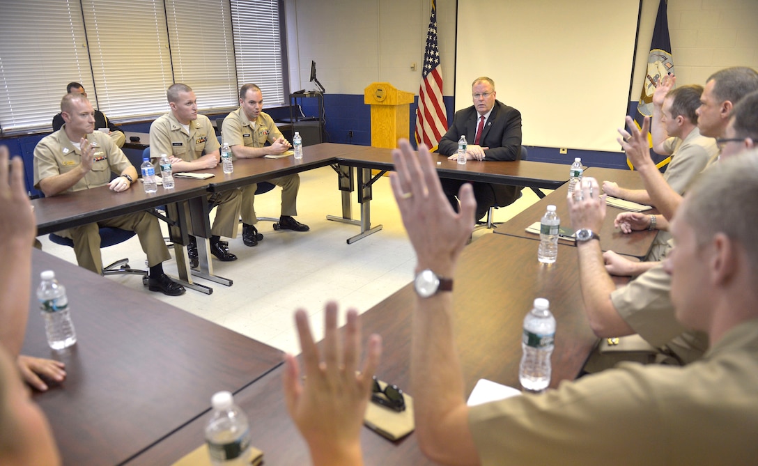 Hands rise after Deputy Defense Secretary Bob Work asks junior naval officers if they are married during a discussion on Groton Submarine Base in New London, Conn., Sept. 22, 2015. DoD photo by Glenn Fawcett