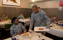 Airman 1st Class Rodnaja Ragin, Pacific Air Forces commanders’ support staff administrator, is served lunch by Master Sgt. Nicholas Headen, 15th Medical Group first sergeant, during the quarterly birthday meal at the Hale Aina Dining Facility, Joint Base Pearl Harbor-Hickam, Hawaii, Sept. 17, 2015. The quarterly birthday meal was the first of its kind at JBPHH in 17 years with the guests of honor being Airmen born in June, July and August. (U.S. Air Force photo by Tech. Sgt. Terri Paden/Released)