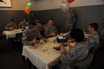 15th Wing Airmen talk with Col. Randy Huiss, 15th Wing commander, while enjoying lunch served to them by members of the Hawaii First Sergeants Association in celebration of their birthday  at the Hale Aina Dining Facility, Joint Base Pearl Harbor-Hickam, Hawaii, Sept. 17, 2015. The guests of honor were Airmen born in June, July and August. The quarterly birthday meal was the first of its kind at JBPHH in 17 years. (U.S. Air Force photo by Tech. Sgt. Terri Paden/Released)