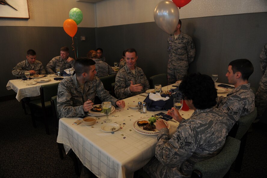 15th Wing Airmen talk with Col. Randy Huiss, 15th Wing commander, while enjoying lunch served to them by members of the Hawaii First Sergeants Association in celebration of their birthday  at the Hale Aina Dining Facility, Joint Base Pearl Harbor-Hickam, Hawaii, Sept. 17, 2015. The guests of honor were Airmen born in June, July and August. The quarterly birthday meal was the first of its kind at JBPHH in 17 years. (U.S. Air Force photo by Tech. Sgt. Terri Paden/Released)