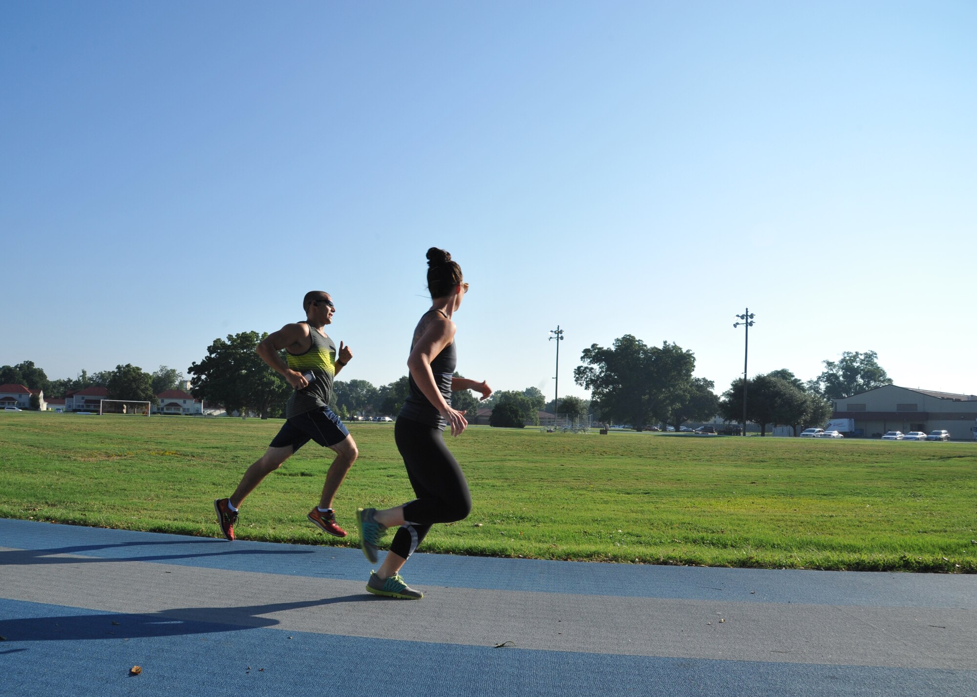 Capt. Lance Gower, 20th Bomb Squadron B-52 Stratofortress copilot, is paced by his wife Kallie during the two-mile run portion of the Iron Airman challenge at Barksdale Air Force Base, La., Sept. 3. Gower scored 375 out a possible 400 points, completing the run in 13:59 and performing 140 push-ups, 100 sit-ups and 30 pull ups. (U.S. Air Force photo/Senior Airman Joseph Raatz)