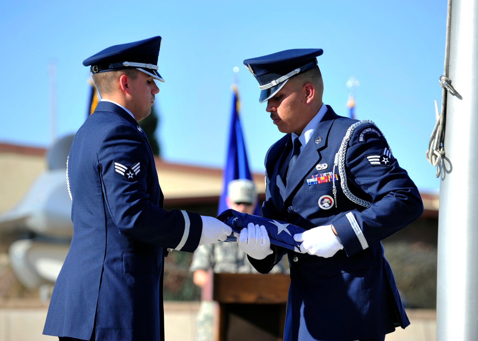 Luke Air Force Base Honor Guard members finish folding the American flag as part of the POW/MIA Recognition Day Retreat ceremony Sept. 18, 2015 near the wing headquarters building at Luke Air Force Base, Ariz. (U.S. Air Force photo by Senior Airman Grace Lee)