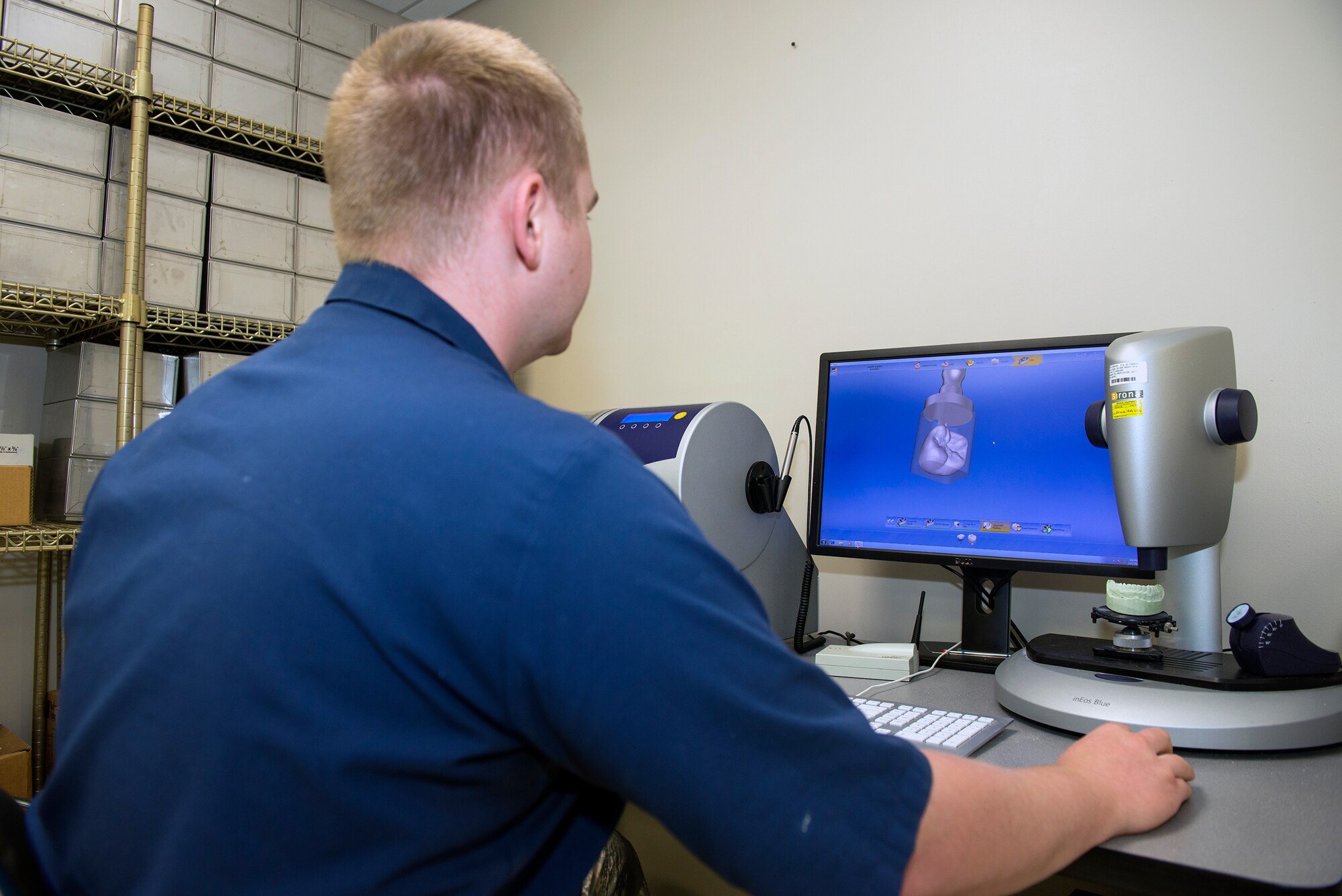 U.S. Air Force Senior Airman Justin Shaw, 23d Aerospace Medicine Squadron dental lab technician, utilizes computer software to design a fabricated ceramic crown mold, Sept. 21, 2015, at Moody Air Force Base, Ga. Dental lab technicians use this software to reduce production times to two hours as opposed to normally taking three to four weeks to produce crown fabrications. (U.S. Air Force photo by Airman 1st Class Greg Nash/Released)