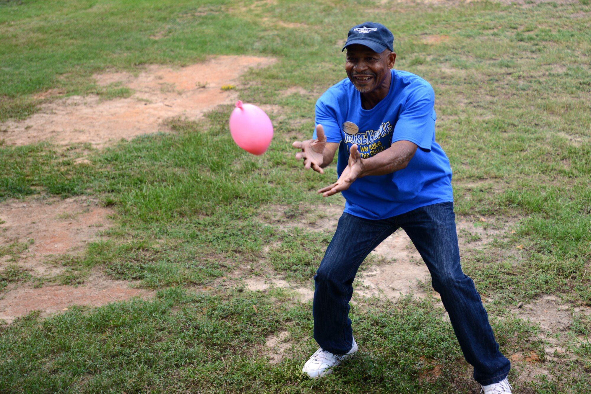 Earl Drakeford, 20th Force Support Squadron custodial worker, tries to catch a water balloon during a balloon toss for International Housekeeping Week at Shaw Air Force Base, S.C., Sept. 18, 2015. Celebrated annually, International Housekeeping Week is held to honor professional housekeepers worldwide. (U.S. Air Force photo by Airman 1st Class Kelsey Tucker/Released)