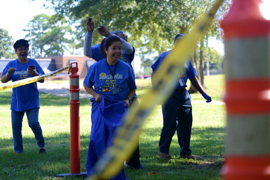 Remy Wilson, 20th Force Support Squadron custodial worker, participates in a sack race at Shaw Air Force Base, S.C., Sept. 14, 2015. The sack race was the first of many events held in celebration of International Housekeeping Week. (U.S. Air Force photo by Airman 1st Class Kelsey Tucker/Released)