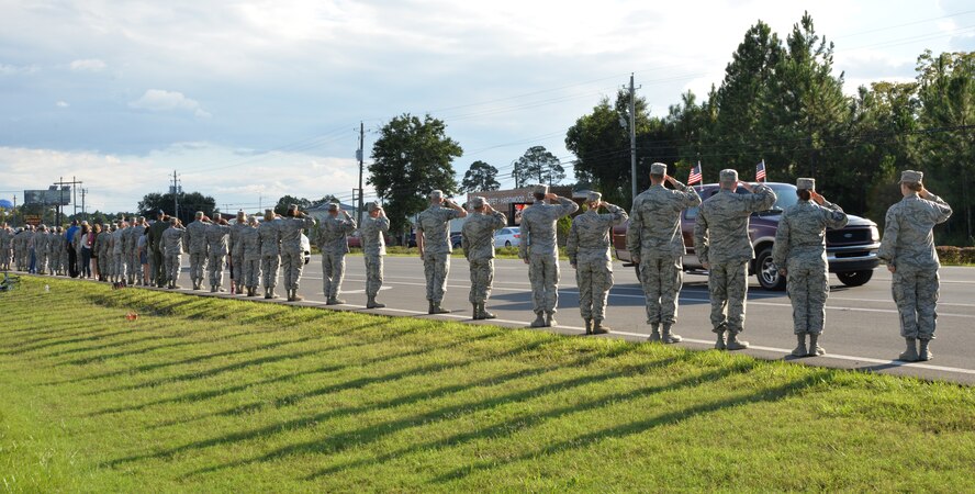 PANAMA CITY, Fla. - Members of the 601st Air Operations Squadron, Tyndall Air Force Base, Fla.,  line the route of the Warrior Beach Retreat parade event Sept. 17 to pay tribute to the wounded warriors as their vehicles pass. The Retreat honors wounded warriors by bringing them and their spouse or caregiver to Panama City Beach, Fla., for a week of rest and relaxation. (Air Force Photo Released/Capt. Jared Scott) 
