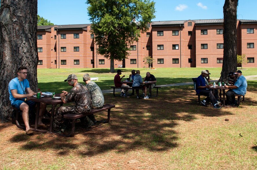 Dorm Airmen and volunteers enjoy food and fellowship during a dorm dwellers barbecue event, Sept. 19, 2015, at Seymour Johnson Air Force Base, North Carolina. Volunteers for the event served more than 110 Airmen and took time to sit down and get to know them. (U.S. Air Force photo/Airman 1st Class Shawna L. Keyes) 