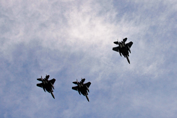F-15E Strike Eagles perform a missing man flyover during the Prisoners of War/Missing in Action ceremony, Sept. 17, 2015, at Seymour Johnson Air Force Base, North Carolina. As four jets flew over the crowd, one separated from the pack, representing the POW/MIAs as the “missing man”. (U.S. Air Force photo/Airman 1st Class Ashley Williamson)