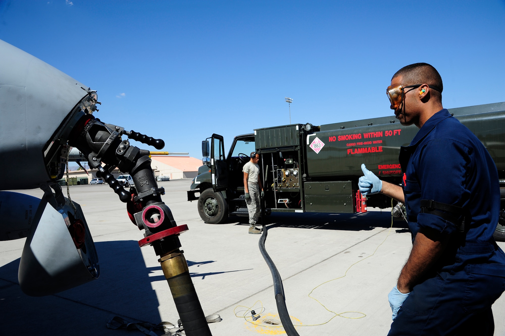 U.S. Air Force Airman 1st Class Michael Soto, 355th Aircraft Maintenance Squadron crew chief, gives thumbs up to start refueling an A-10 Thunderbolt II during its recovery at Nellis Air Force Base, Nev., Sept. 16, 2015. The A-10s, stationed out of Davis-Monthan AFB, Ariz., joined seven additional units from around the country to participate in Green Flag-West 15-10, a 2-week advanced, realistic, and relevant air-to-surface training exercise. (U.S. Air Force photo by Senior Airman Betty R. Chevalier/Released)