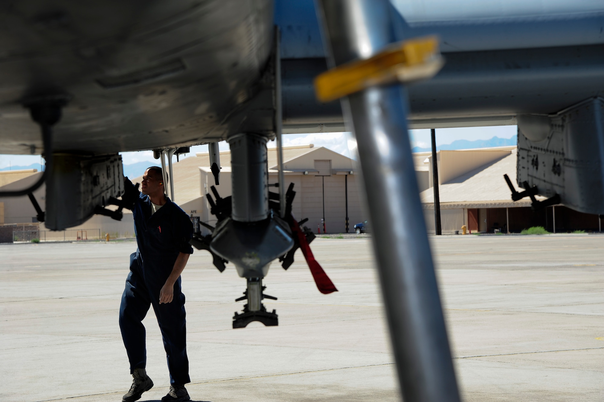 U.S. Air Force Airman 1st Class Michael Soto, 355th Aircraft Maintenance Squadron crew chief, checks an A-10 Thunderbolt II for damage or missing parts during a basic post flight inspection at Nellis Air Force Base, Nev., Sept. 16, 2015.  The 355th AMXS maintained eight A-10s from the 357th Fighter Squadron while participating in Green Flag-West 15-10. (U.S. Air Force photo by Senior Airman Betty R. Chevalier/Released)