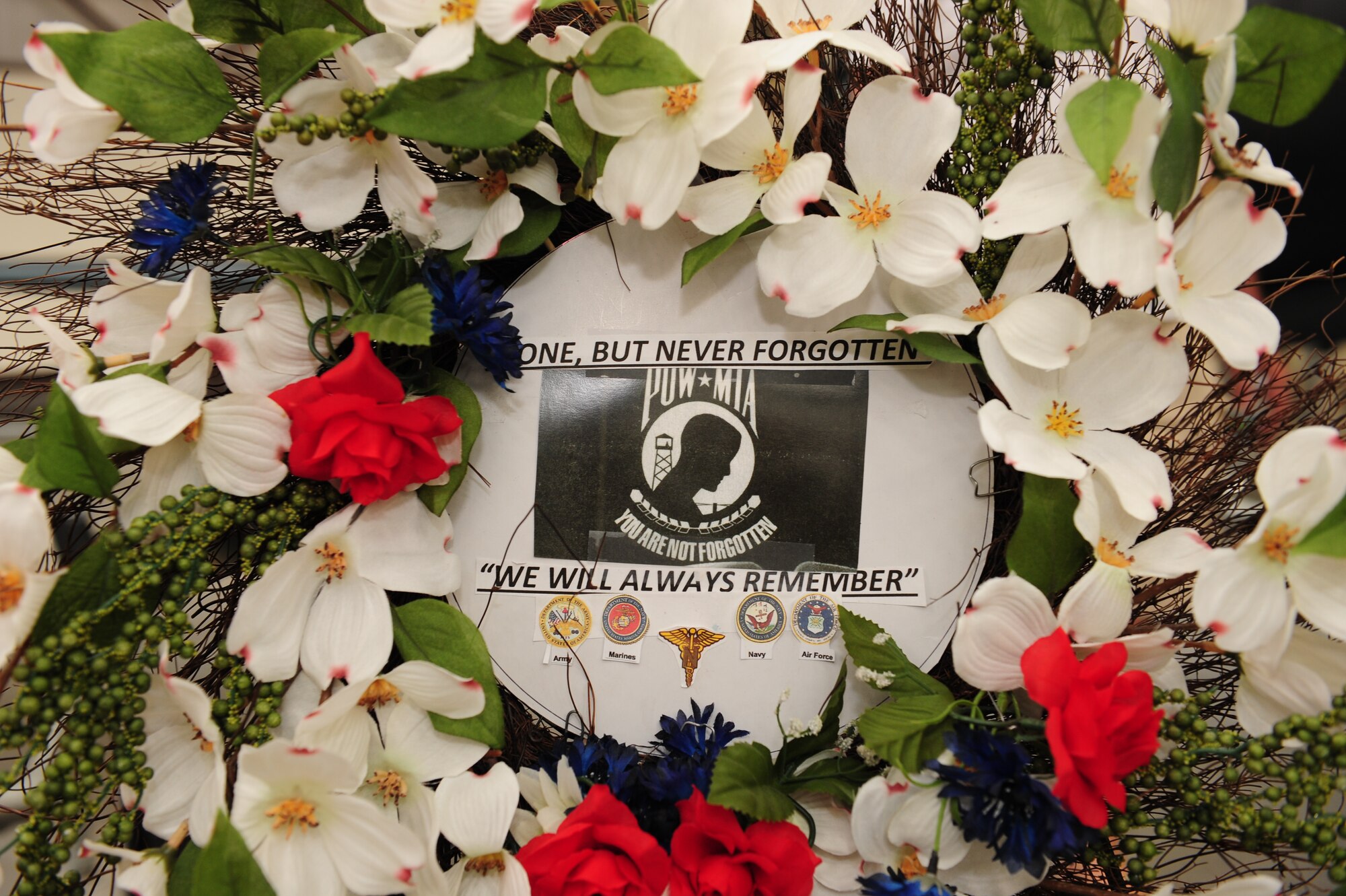 A wreath honoring prisoners of war and those who are missing in action sits on display during a POW/MIA Remembrance Ceremony at the Pima Air and Space Museum in Tucson, Ariz., Sept. 18, 2015. The wreath was crafted and donated by Ms. Helen Glass, a U.S. Navy World War II veteran who served in Women Accepted for Volunteer Emergency Service. (U.S. Air Force photo by Senior Airman Cheyenne A. Powers/ Released)