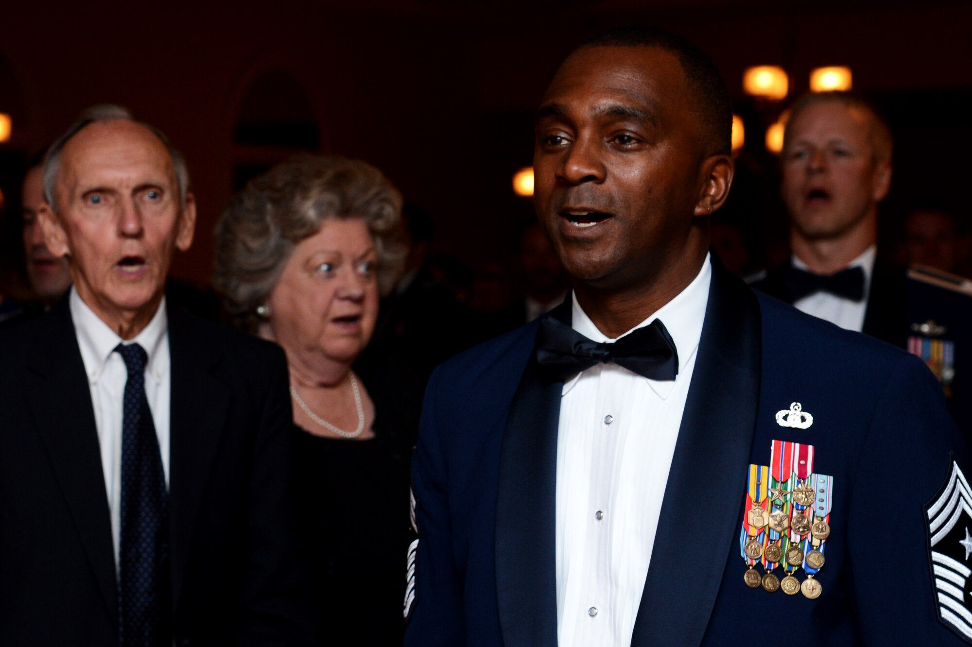 U.S. Air Force Chief Master Sgt. Christopher McKinney, 20th Fighter Wing command chief, sings the Air Force Song during the Air Force Ball at Shaw Air Force Base, S.C., Sept. 18, 2015. Team Shaw celebrated the 68th birthday of the Air Force by hosting a ball at the Carolina Skies Club and Conference Center here. (U.S. Air Force photo by Senior Airman Jonathan Bass/Released)