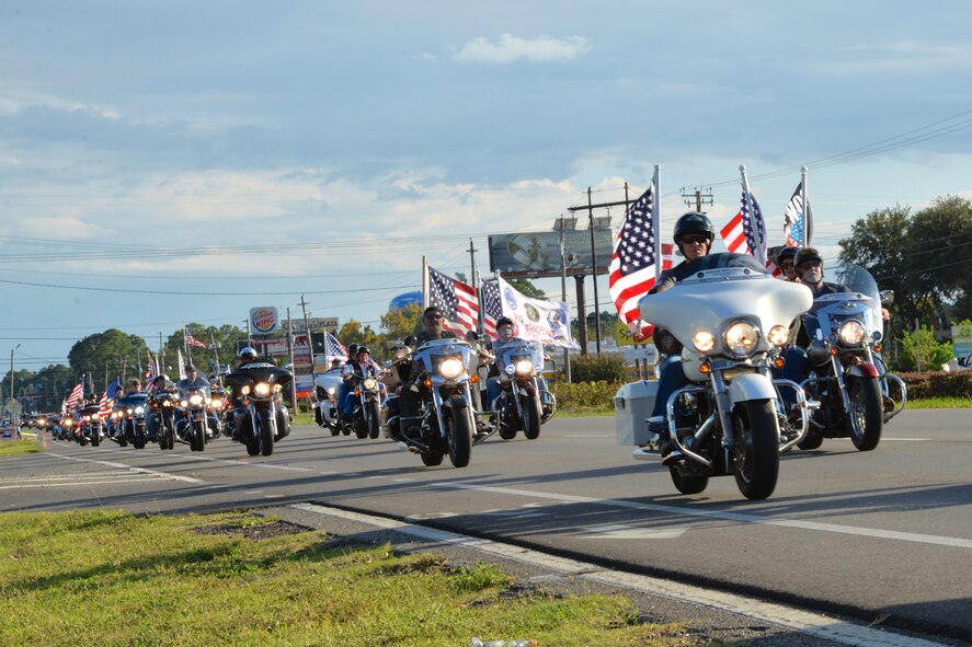PANAMA CITY, Fla. - Proudly flying the Colors, motorcyclists lead the escort detail for the Warrior Beach Retreat parade event Sept. 17. All along the route, which went from Panama City Beach to a local church in Panama City, well wishers paid tribute to the wounded warriors with flags, waves and rendered salutes. The Retreat honors wounded warriors by bringing them and their spouse or caregiver to Panama City Beach, Fla., for a week of rest and relaxation. (Air Force Photo Released/Capt. Jared Scott) 
