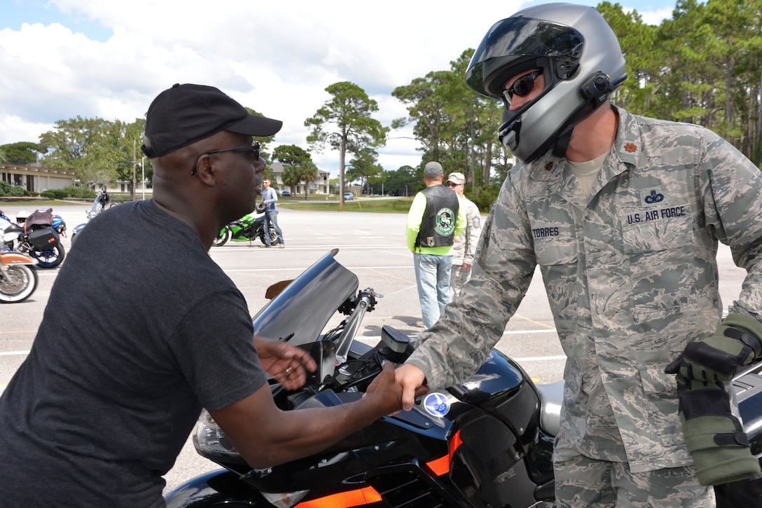 02.	TYNDALL AIR FORCE BASE, Fla. - Lt. Col. John Taylor, Continental U.S. Aerospace Defense Region- 1st Air Force (Air Forces Northern) Chief, Space Operations, greets Maj. Michael Torres, AFNORTH Vice Commander Executive Officer, prior to participating in an escort detail for the Warrior Beach Retreat parade event Sept. 17. Taylor and Torres joined other motorcyclists to escort vehicles of wounded warriors from Panama City Beach to an inaugural welcome at a Panama City church.  The Retreat honors wounded warriors by bringing them and their spouse or caregiver to Panama City Beach, Fla., for a week of rest and relaxation. (Air Force Photo Released/Mary McHale)