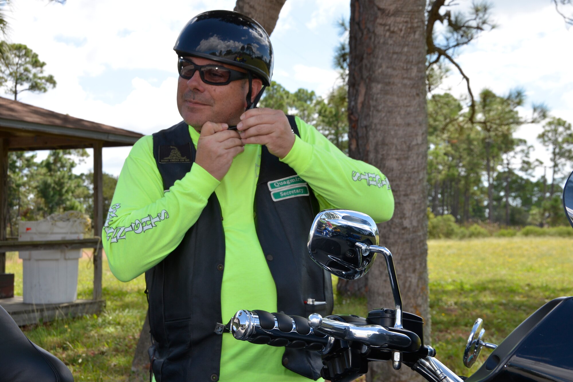 TYNDALL AIR FORCE BASE, Fla. - Master Sgt. Glen Webb, 101st Air Communications Squadron and member of Tyndall’s Green Knights Motorcycle Club, fastens his helmet prior to participating in an escort detail for the Warrior Beach Retreat parade event Sept. 17. Webb joined other motorcyclists to escort vehicles of wounded warriors from Panama City Beach to an inaugural welcome at a Panama City church. The Retreat is honors wounded warriors by bringing them and their spouse or caregiver to Panama City Beach, Fla., for a week of rest and relaxation. (Air Force Photo Released/Mary McHale)