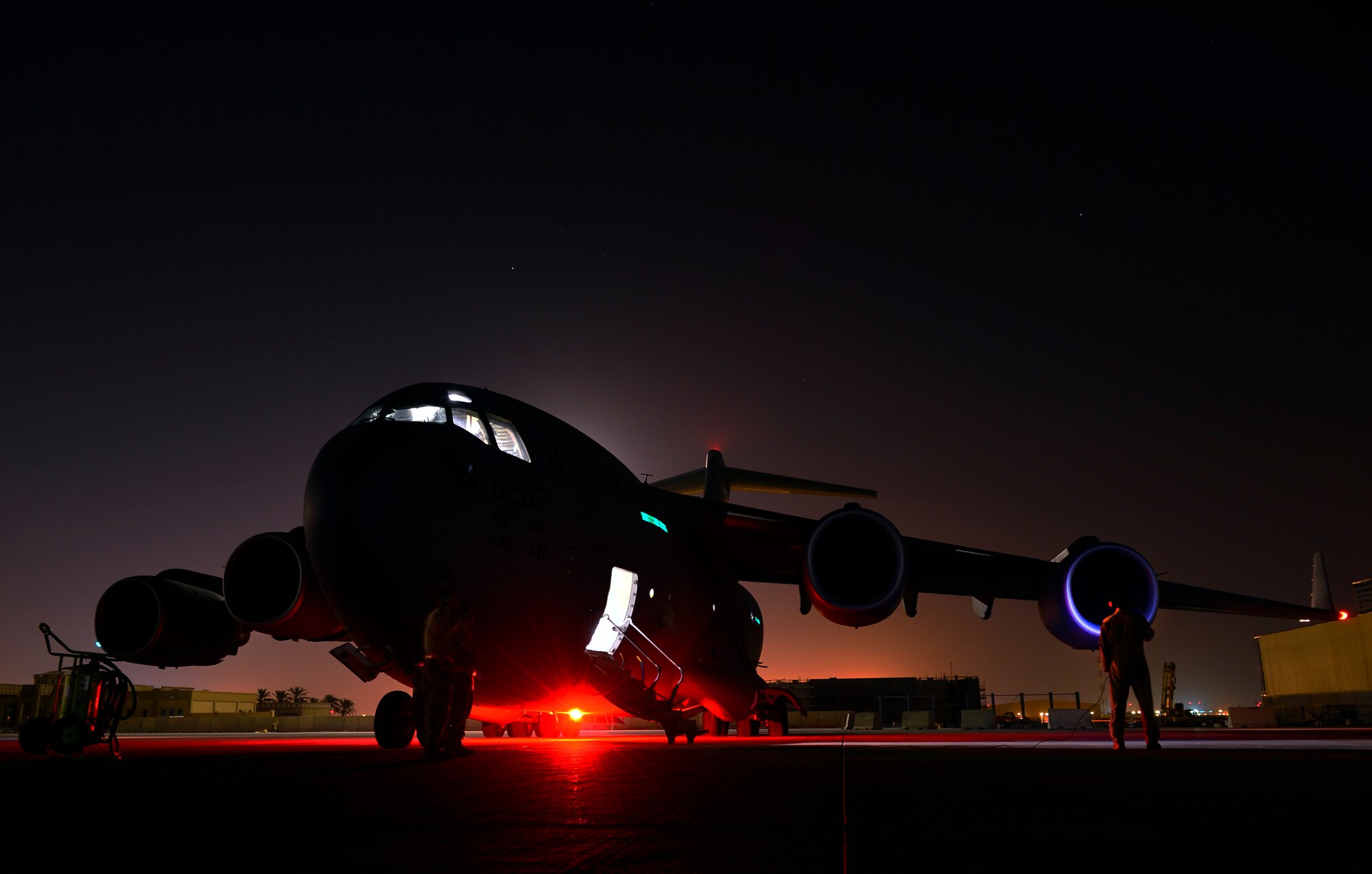 Senior Airman Jon Woerzburger awaits engine start prior to a Aug. 30, 2014, humanitarian airdrop mission over Amirli, Iraq. The two C-17 Globemaster IIIs dropped 79 container delivery system bundles of fresh drinking water totaling 7,513 gallons. In addition, two U.S. C-130 Hercules aircraft dropped 30 bundles totaling 3,032 gallons of fresh drinking water and 7,056 meals ready to eat. Woerzburg is a C-17 flying crew chief with the 816th Expeditionary Airlift Squadron. (U.S. Air Force photo/Staff Sgt. Vernon Young) 

