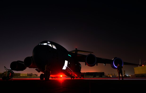 Senior Airman Jon Woerzburger awaits engine start prior to a Aug. 30, 2014, humanitarian airdrop mission over Amirli, Iraq. The two C-17 Globemaster IIIs dropped 79 container delivery system bundles of fresh drinking water totaling 7,513 gallons. In addition, two U.S. C-130 Hercules aircraft dropped 30 bundles totaling 3,032 gallons of fresh drinking water and 7,056 meals ready to eat. Woerzburg is a C-17 flying crew chief with the 816th Expeditionary Airlift Squadron. (U.S. Air Force photo/Staff Sgt. Vernon Young) 
