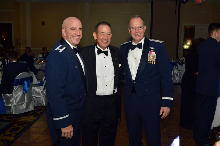 Air Force Col. Kenneth Moss, 43rd Airlift Group commander, left, and Brig. Gen. James Scanlan, mobilization assistant to the U.S. Air Force Expeditionary Center commander, right, pose for a photo with Jim Scott, 43rd AG honorary commander, during the Pope Field Air Force Ball Sept. 18, Fayetteville, North Carolina. Scanlan visited 43rd Airlift Group Airmen during his visit to Pope Army Airfield, North Carolina, Sept. 17-18. (U.S. Air Force photo/Marvin Krause)
