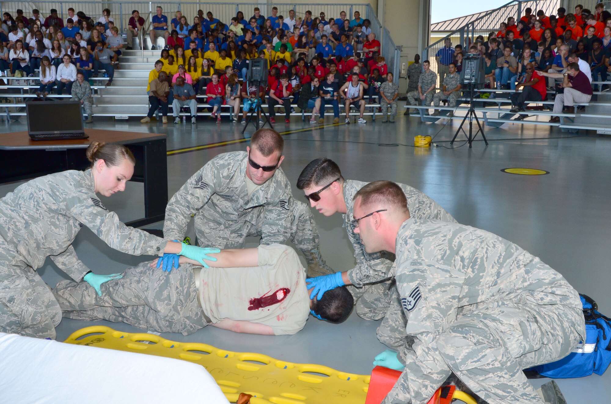 Airmen assigned to the 81st Medical Group treat a victim during a dramatization of an office shooting during a science, technology, engineering and mathematics day for South Mississippi high schoolers at Keesler Air Force Base September 18, 2015. (U.S. Air Force Photo/Master Sgt. Brian Lamar)