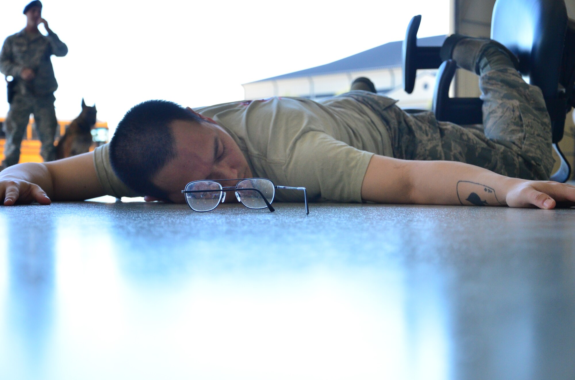 Staff Sgt. Chhouen Prach, 81st Diagnostic and Therapeutics Squadron lab technician, plays the role of a shooting victim during a science, technology, engineering and mathematics day for South Mississippi high schoolers at Keesler Air Force Base September 18, 2015. (U.S. Air Force Photo/Master Sgt. Brian Lamar)