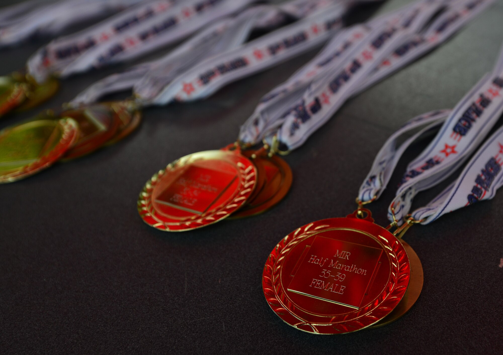 The top three Mulberry Island Half Marathon runners in each age and gender category were awarded medals during a ceremony at the end of the run at Fort Eustis, Va., Sept. 19, 2015.  The top three males and females overall were also awarded plaques and cash prizes.  (U.S. Air Force photo by Staff Sgt. Natasha Stannard/Released)