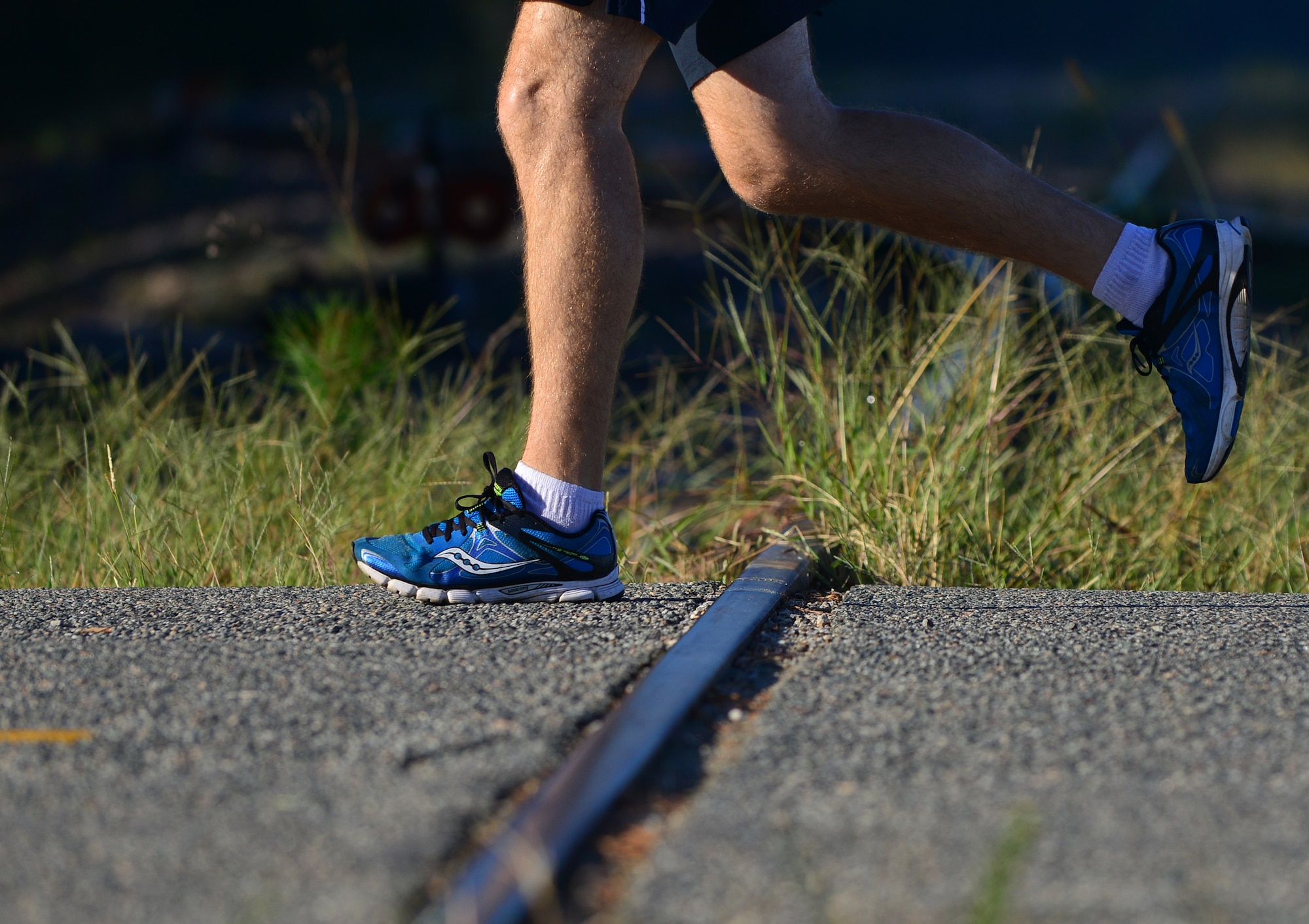 Mulberry Island Half Marathon participants run over train tracks at Fort Eustis, Va., Sept. 19, 2015.  As the longest-held race at Fort Eustis, the 5K and half-marathon are intended to bring the military and local communities together while giving participants a tour of the island, which was established in colonial times.  (U.S. Air Force photo by Staff Sgt. Natasha Stannard/Released)
