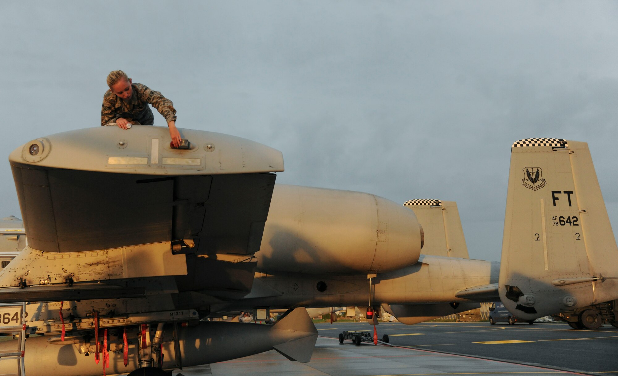 A crew chief from the 74th Expeditionary Fighter Squadron checks a light during post-flight maintenance on an U.S. Air Force A-10C Thunderbolt IIs on the flightline at Amari Air Base, Estonia, Sept 21, 2015. The aircraft and Airmen will forward deploy to locations in Eastern European NATO countries as part of the Theater Security Package. (U.S. Air Force photo by Andrea Jenkins/Released)