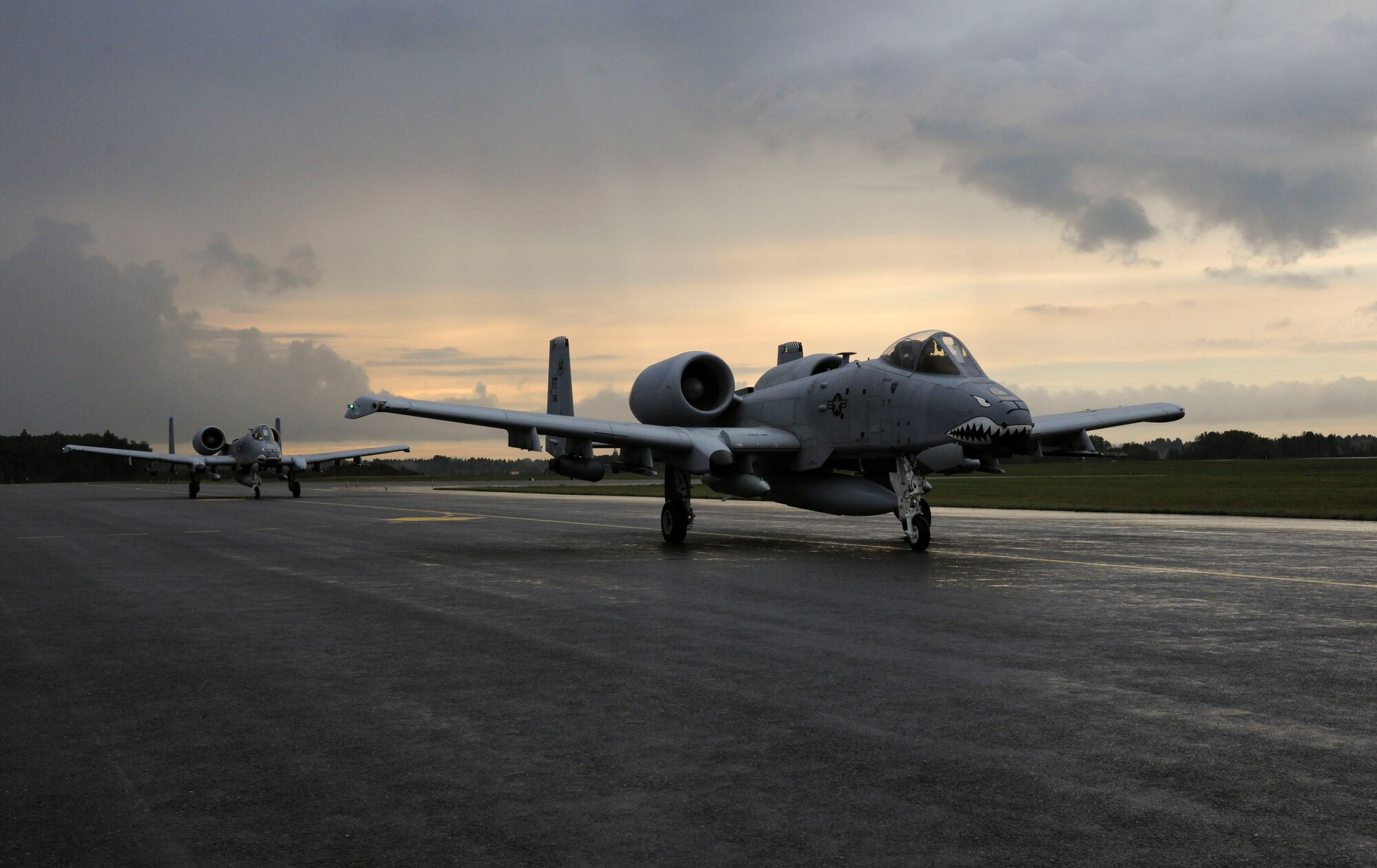 Two U.S. Air Force A-10C Thunderbolt IIs assigned to the 74th Expeditionary Fighter Squadron taxi down the runway after landing at Amari Air Base, Estonia Sept 21, 2015. These aircraft, deployed as a Theater Security Package in support of Operation Atlantic Resolve, will train with NATO allies to strengthen interoperability. (U.S. Air Force photo by Andrea Jenkins/Released)