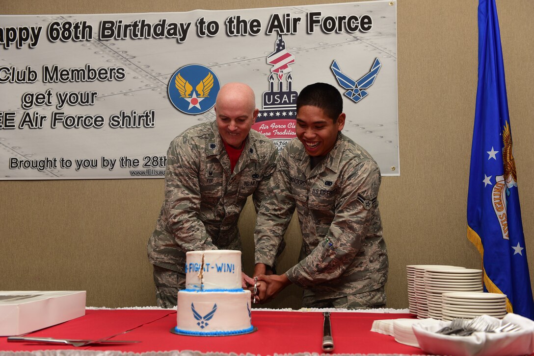 Lt. Col. Norman Fox, 28th Medical Support Squadron commander (left), and Airman 1st Class Peter John Mandadero, 28th Logistics Readiness Squadron fuels facilities technician (right), perform a cake-cutting ceremony to commemorate the Air Force’s 68th birthday at Ellsworth Air Force Base, S.D., Sept. 18, 2015. The ceremony symbolizes passing wisdom from senior to junior servicemembers. (U.S. Air Force photo by Airman 1st Class James L. Miller/Released)