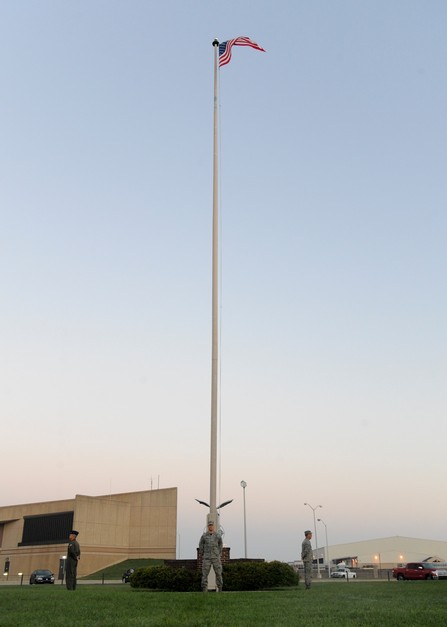 Col. Michael Grismer, 436th Airlift Wing commander, center, stands watch with other members of Team Dover leadership at base flag pole during the National POW/MIA Recognition Day vigil Sept. 18, 2015, at Dover Air Force Base, Del. The senior leaders started the vigil and members of Team Dover took 10-minute rotations standing guard. (U.S. Air Force photo/Senior Airman William Johnson)