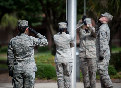 A Joint Base Charleston Honor Guard detail team performs a retreat ceremony Sept. 18, 2015, at the base flagpole on JB Charleston – Air Base, S.C. The ceremony included a 21-gun salute by the Honor Guard, a wreath-laying and a live bugle performance in recognition of captured and missing U.S. servicemembers. (U.S. Air Force photo/Airman 1st Class Clayton Cupit)