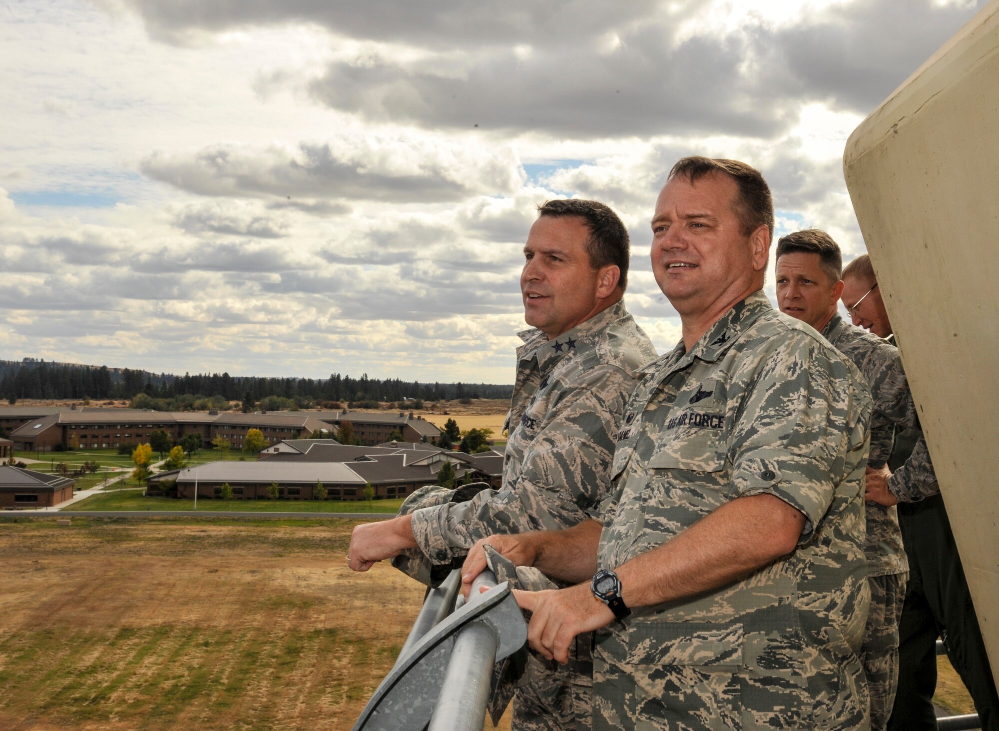 Maj. Gen. Thomas J. Sharpy, 18th Air Force commander, and Col. Brian McDaniel, 92nd Air Refueling Wing commander, overlook the flightline and the U.S. Air Force Survival School Sept. 18, 2015, at Fairchild Air Force Base, Wash. Sharpy visited Fairchild to present the Air Traffic Control Facility of the Year award and received a tour of the base as well. Fairchild is home to a wide variety of units and missions. Most prominent is its air refueling mission, with two wings, one active, the 92nd Air Refueling Wing, and one Air National Guard, the 141st ARW. Other units here include the Air Force Survival, Evasion, Resistance and Escape school, medical detachments, a weapons squadron and the Joint Personnel Recovery Agency. (U.S. Air Force photo/Airman 1st Class Taylor Bourgeous)