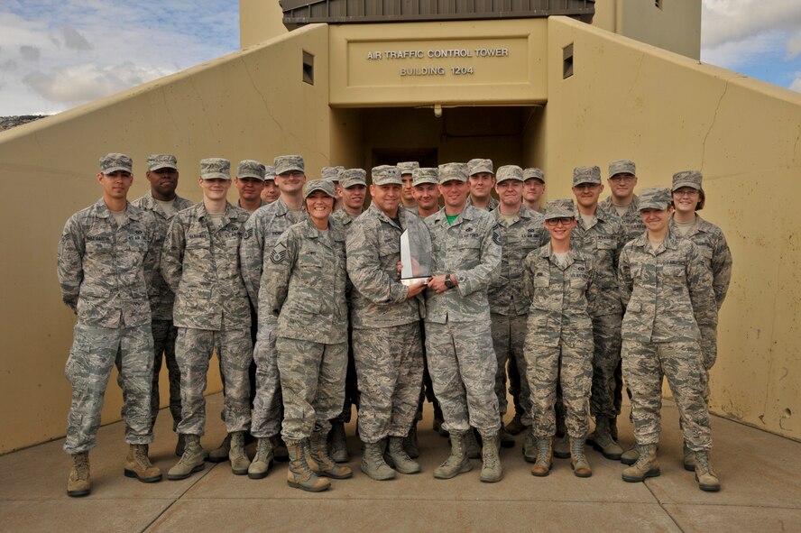 Maj. Gen. Thomas J. Sharpy, 18th Air Force commander, presents the Air Traffic Control Facility of the Year award to the 92nd Operations Support Squadron ATC members Sept 18, 2015, at Fairchild Air Force Base, Wash. This award is given to ATC facilities that make notable contributions to the quality, safety and emergency situations in air traffic control. With 35 KC-135 Stratotankers, the ATC members are in charge of monitoring all incoming and outgoing aircraft in order to prevent accidents. (U.S. Air Force photo/Airman 1st Class Taylor Bourgeous)