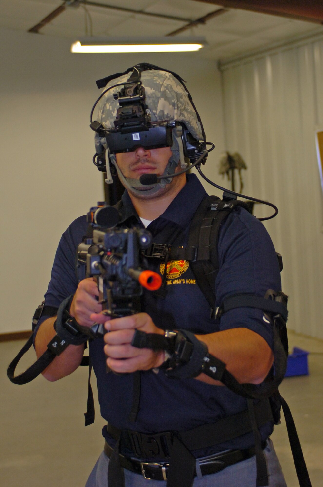 Marc Zamarin, the director of Ticket Sales and Service for the Philadelphia Soul, operates in a simulated combat village environment against insurgents with the Dismounted Soldier Training System (DSTS) along with his team manned by United States Army Support Activity, Fort Dix Commander, Col. Shelley L. Balderson and Major Simon Flake, headquarters company commander.  (Image by Master Sgt. David Moore/NJARNG)   
