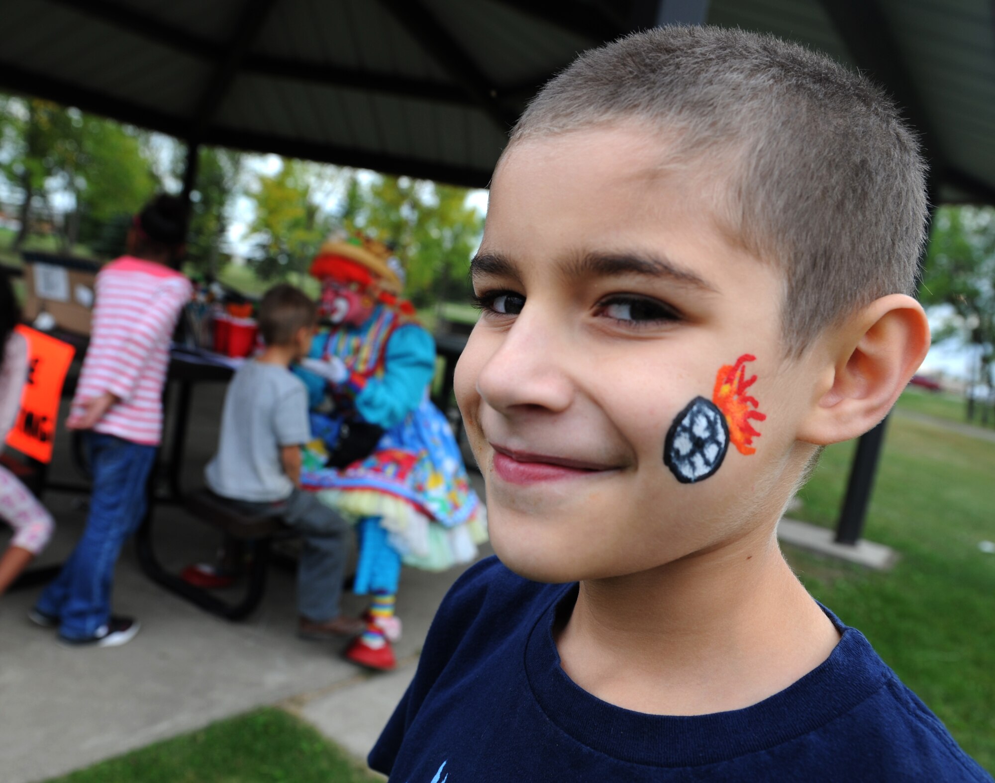 Parker Trujillo shows off his newly painted face at Bud Ebert Park at Minot AFB, N.D. Sept. 16, 2015.Face painting was part of a carnival that the base chapel put on for the Airmen and their families of Minot AFB. (U.S. Air Force photo by Staff Sgt. Chad Trujillo)

