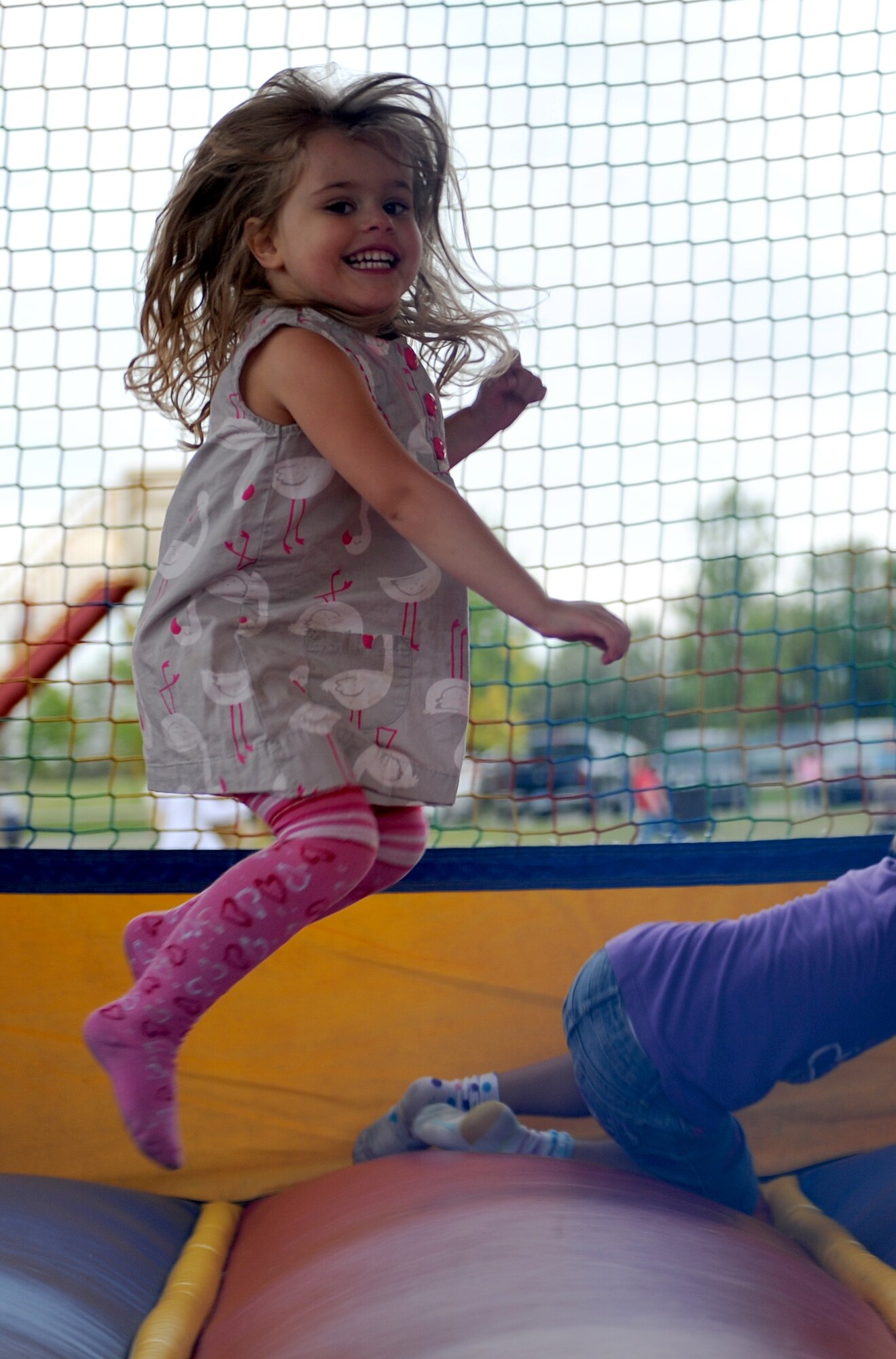Qwynn Trujillo jumps in a bouncy house at Bud Ebert Park on Minot AFB, N.D. Sept. 16, 2015. The bouncy house was part of a carnival that base chapel put on for the Airmen and their families of Minot AFB. (U.S. Air Force photo by Staff Sgt. Chad Trujillo)