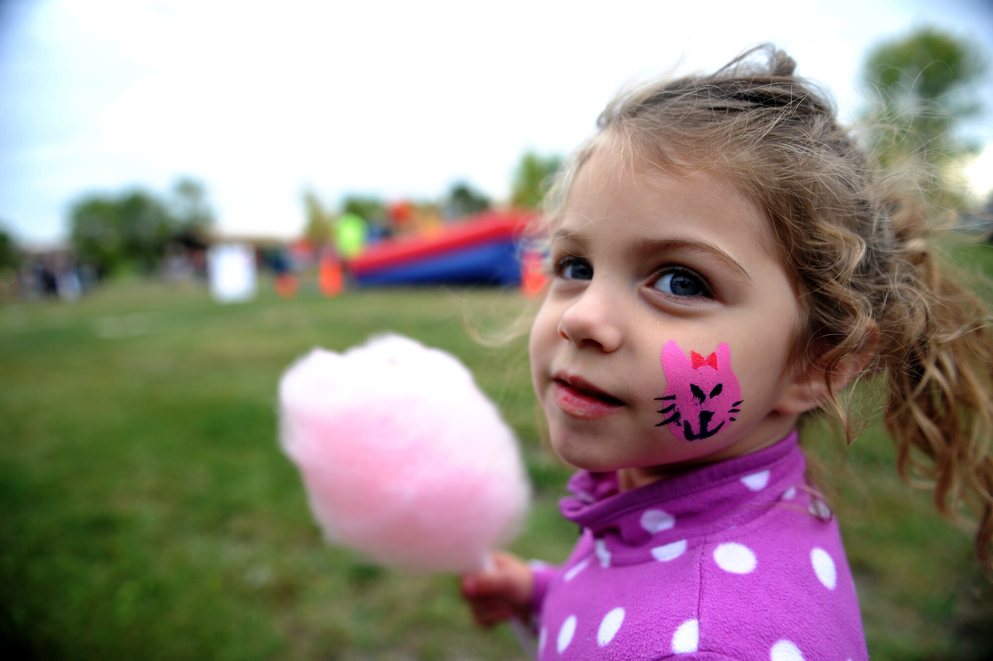 Jailyn Reimer with cotton candy at Bud Ebert Park at Minot AFB, N.D. Sept. 16, 2015. Cotton candy was part of the goodies given out during the carnival the base Chapel put on for the Airmen and their families of Minot AFB. (U.S. Air Force photo by Staff Sgt. Chad Trujillo)