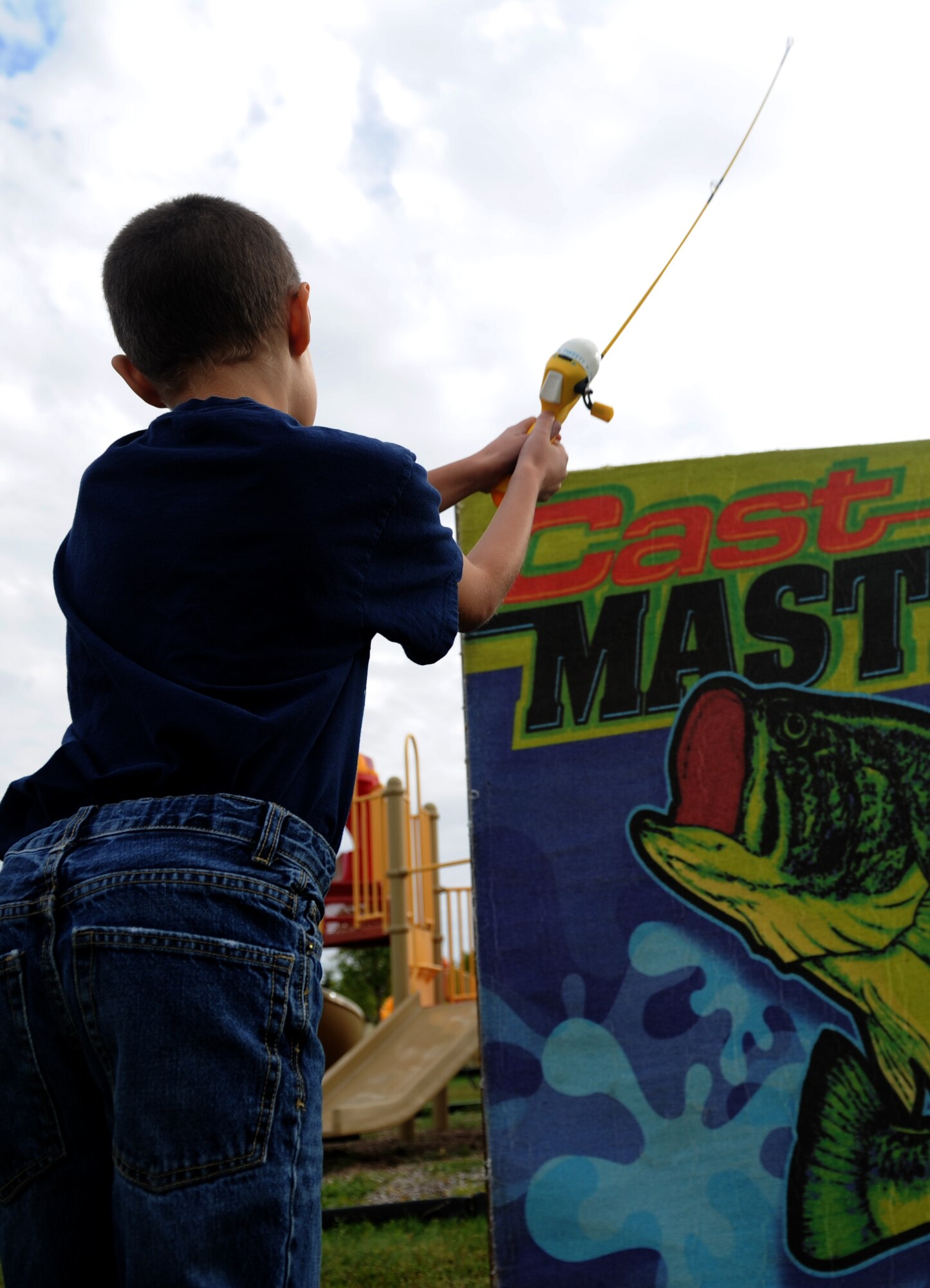 Parker Trujillo plays a fishing game at Bud Ebert Park at Minot AFB, N.D. Sept. 16, 2015. The  fishing game was part of a carnival the base chapel put on for the Airmen and their families of Minot AFB. (U.S. Air Force photo by Staff Sgt. Chad Trujillo)