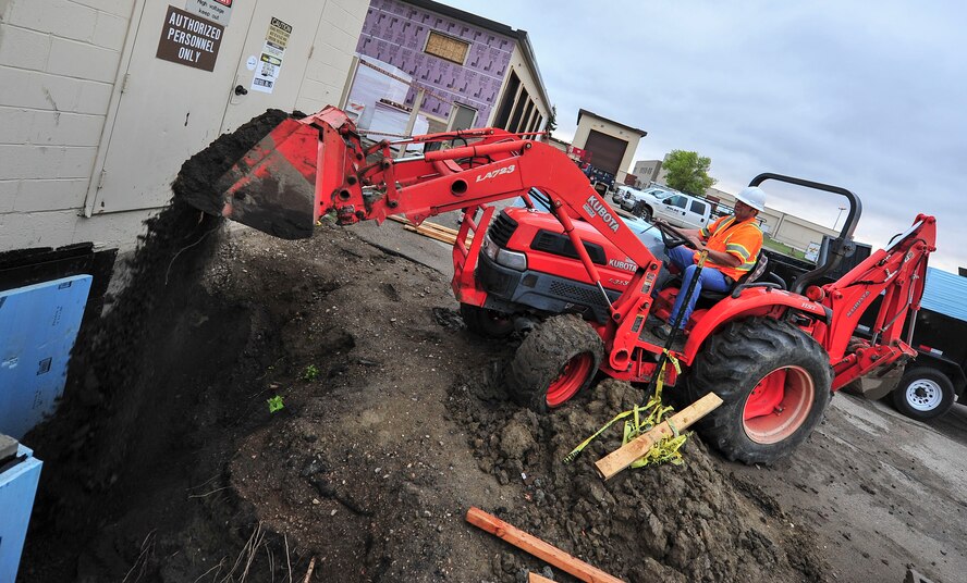William Marier, contractor, fills in dirt for a new airfield lighting system building sidewalk at Minot Air force Base, N.D., Sept. 17, 2015. The building is receiving new sewer systems, an updated internal structure, new sidewalks and electrical systems. (U.S. Air Force photo/Senior Airman Stephanie Morris)