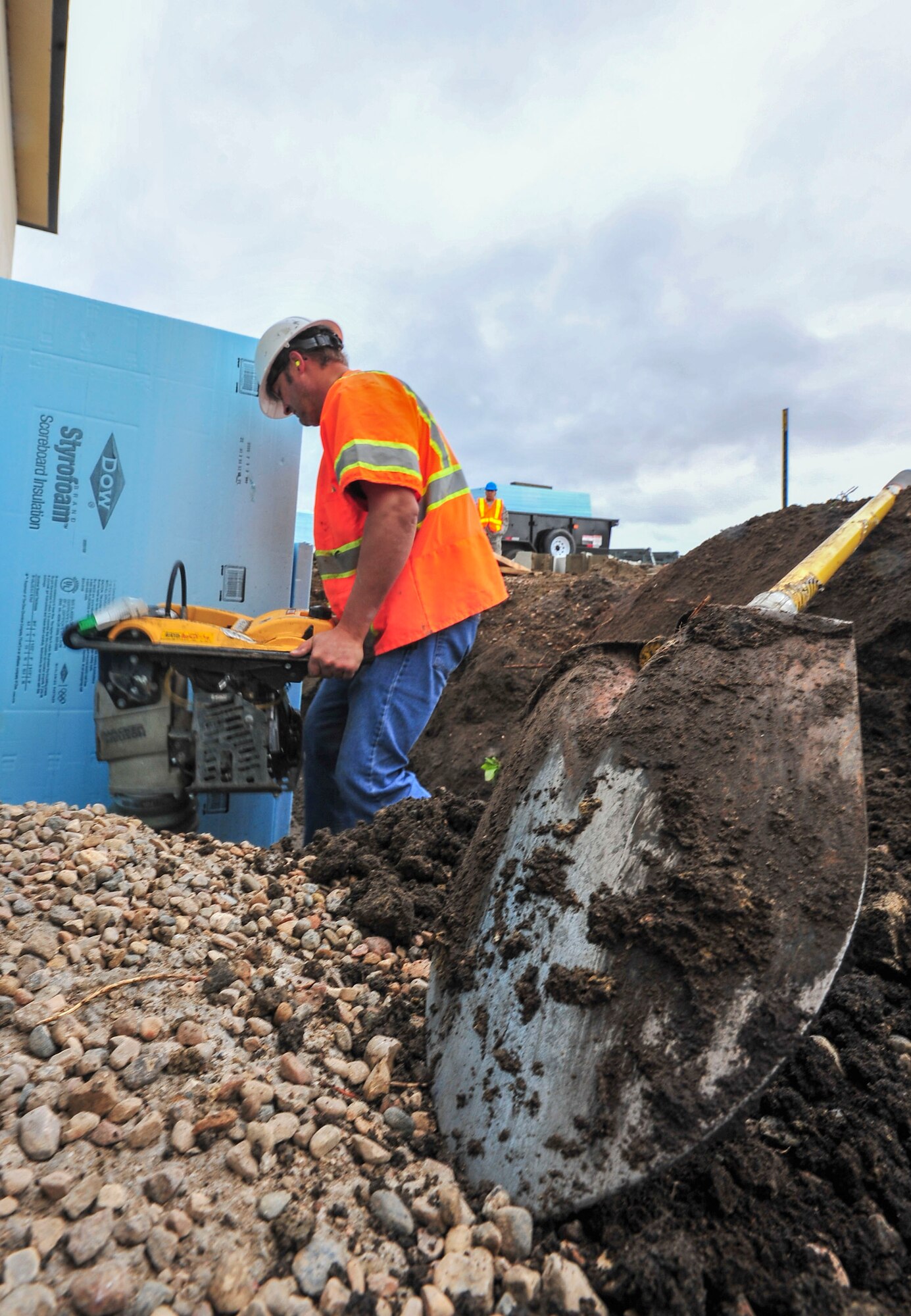William Marier, contractor, levels dirt for a new airfield lighting system building sidewalk at Minot Air force Base, N.D., Sept. 17, 2015. Marier has been working on the project, which is slated for completion in July 2016, for approximately two months. (U.S. Air Force photo/Senior Airman Stephanie Morris)